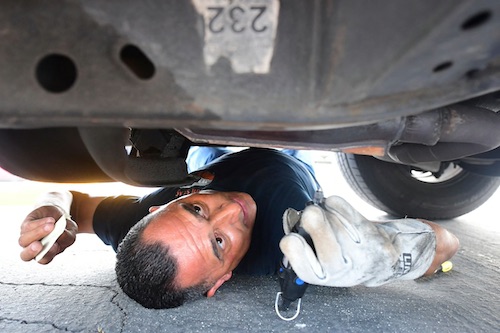 man working under car